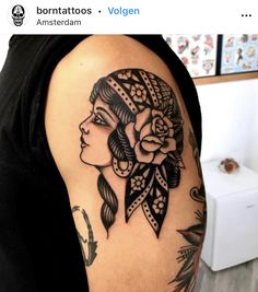 a woman's arm with tattoos on it and a rose in the middle of her head