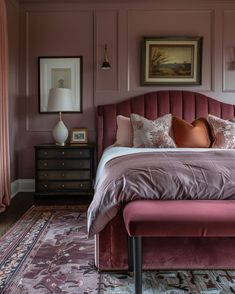 a bedroom with pink walls and furniture