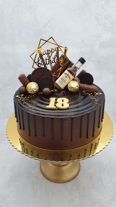 a birthday cake decorated with chocolate and gold decorations