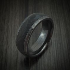 a wedding band is shown on top of a wooden table