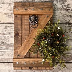 a wreath is hanging on the side of a barn door