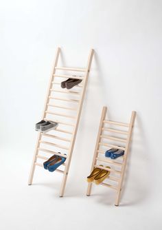 two wooden ladders with shoes on them