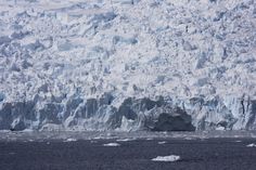 an iceberg is shown in the middle of the ocean