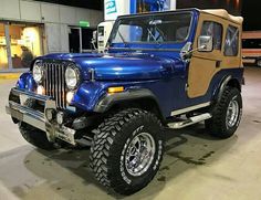 a blue jeep parked in front of a building