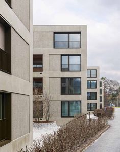 an apartment building with several balconies on each floor and windows in the middle