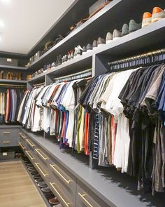 the closet is full of men's shirts and shoes, all in different colors