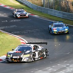 two racing cars driving on a race track