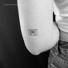 a person with a small tattoo on their arm that has an old school cassette tape