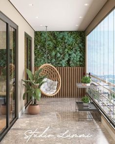 a balcony with a hanging chair, potted plant and glass doors to the outside