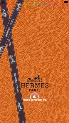 an orange leather book cover with the words hermes paris on it and two black strips