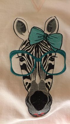 a close up of a shirt with a zebra wearing glasses and a bow on it's head