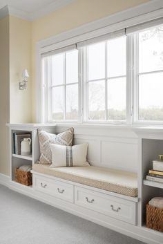 a window seat with pillows on it in a room