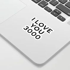 a laptop computer with i love you sticker on the keyboard