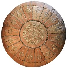 an intricately designed round leather cushion