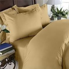 an image of a bed with pillows and sheets on top of each other in the room