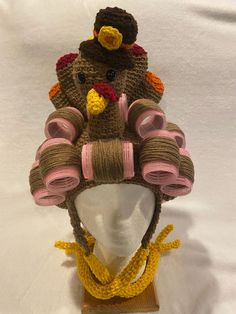 there is a knit turkey hat on top of a mannequin's head