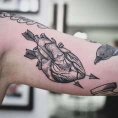 a heart with arrows and an arrow on the arm