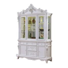 a white china cabinet with glass doors and drawers on the bottom, in front of a white background