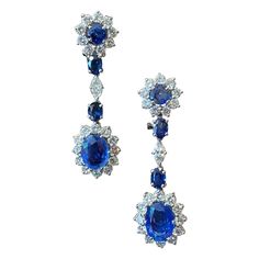 1950s Ceylon Sapphire and Diamond Cluster Drop Earrings in Platinum and White Gold, Portuguese. Each earring is designed as a circular sapphire and round brilliant-cut diamond cluster surmount suspending a larger oval sapphire and round brilliant-cut diamond cluster, articulated through two smaller oval-shape sapphires interspersed with a marquise brilliant-cut diamond. The main sapphires are of a breathtaking cornflower blue color, geographic origin opinion: Ceylon (Sri Lanka). This pair of ear Ceylon Sapphire, Royal Jewels, Natural Sapphire, Diamond Cluster, Sapphire Diamond, Round Brilliant Cut Diamond, Brilliant Cut Diamond, Sri Lanka, Blue Sapphire