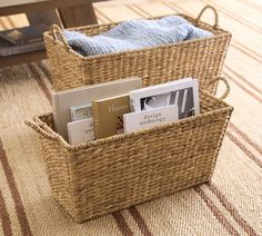 a wicker basket filled with books on top of a rug