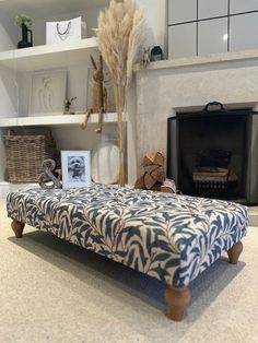 a blue and white bench sitting in front of a fire place next to a fireplace