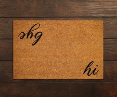 a brown door mat with the word hi written on it in cursive writing