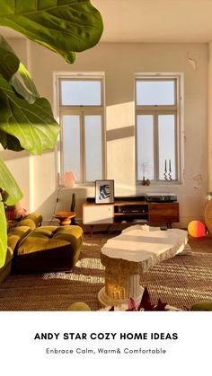 a living room filled with lots of furniture and plants in front of two large windows