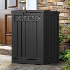 a black trash can sitting in front of a door