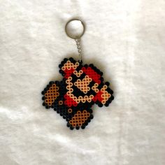 a keychain made to look like an old school video game character from the 80s