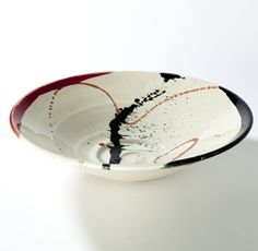 a white and black bowl sitting on top of a table