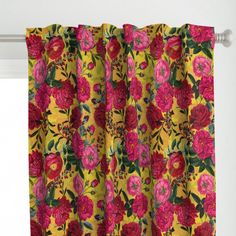 a yellow curtain with pink and red flowers on it