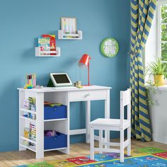 a child's desk and chair set up in a room with bright blue walls