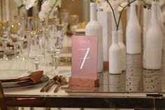 the table is set with wine glasses and place cards