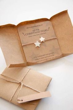 an open gift box with a silver star on it