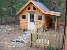 a small wooden shed with a porch and fence