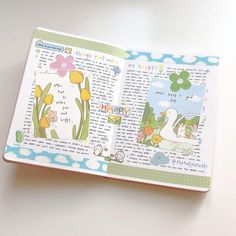 an open children's book with pictures of animals and flowers on the pages, sitting on a table