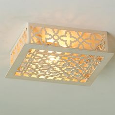 a square light fixture with an intricate design