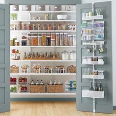 an open pantry filled with lots of food and drink bottles next to two opened doors