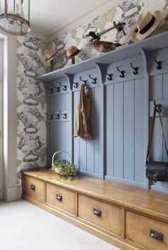 an image of a room with blue cabinets and hats on the top shelf in front of it