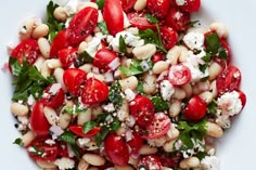 a white plate topped with beans and tomatoes