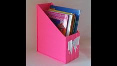 a pink book holder filled with lots of books