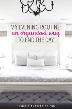 a white bed sitting under a chandelier next to a window with the words, my evening routine an organized way to end the day