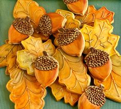 an arrangement of decorative leaves and acorns on a table