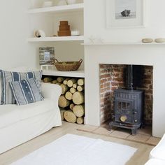 a living room filled with furniture and a fire place next to a white couches