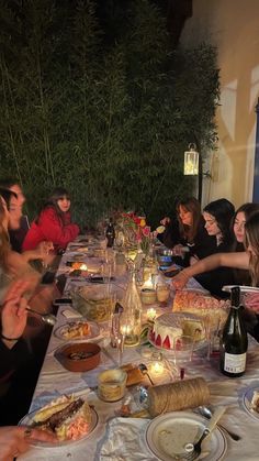 a group of people sitting around a table eating food