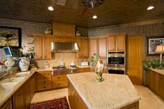 a large kitchen with wooden cabinets and granite counter tops