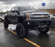 a large black truck parked in a parking lot