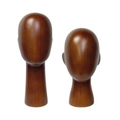 two wooden dolls are standing next to each other