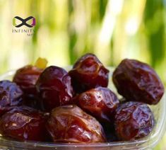 a glass bowl filled with raisins sitting on top of a table