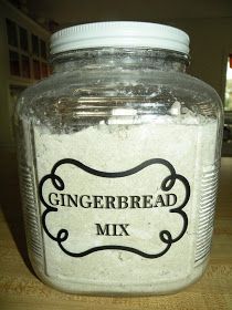 a glass jar filled with gingerbread mix on top of a wooden table next to a window